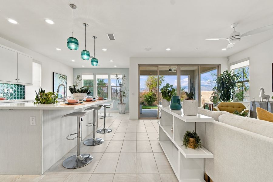 Kitchen island with bar stools opening to the living area
