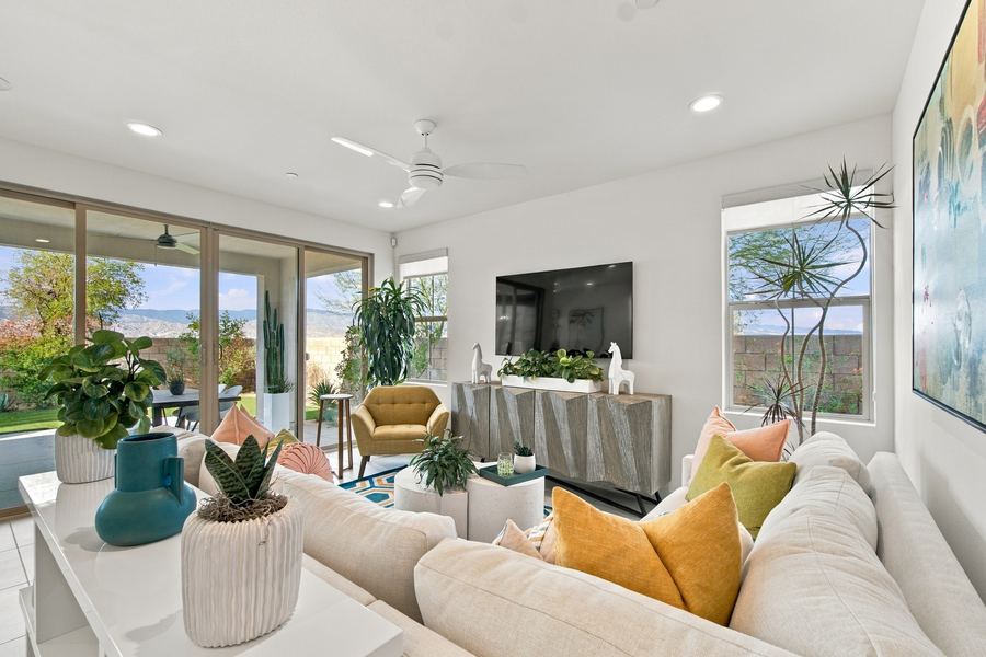 Living room with sectional, mustard armchair and sliding glass doors