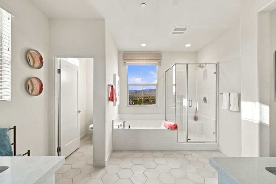 Primary bathroom with soaking tub, glass shower and mountain view