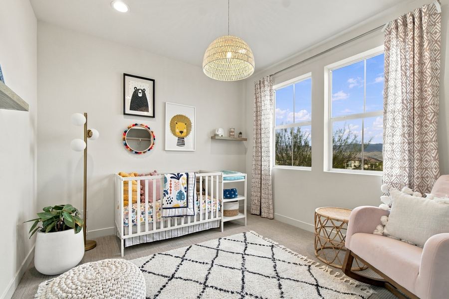 Nursery with crib, rattan pendant light and blush rocking chair